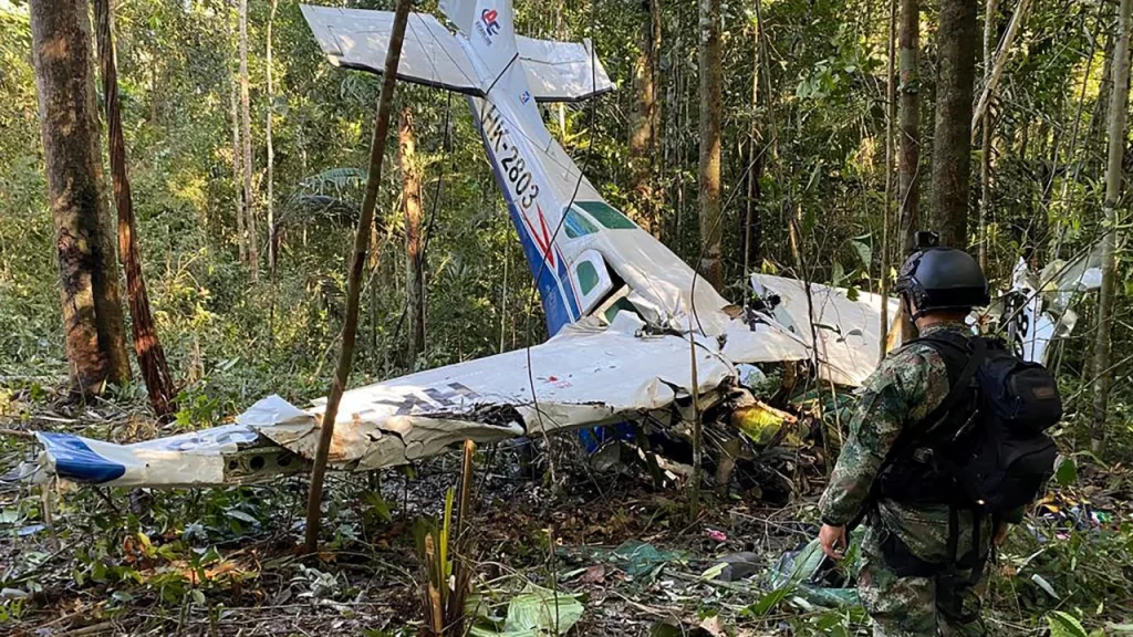 A soldier stands next to the wreckage of a plane during the search for child survivors from a plane that crashed in the Amazon