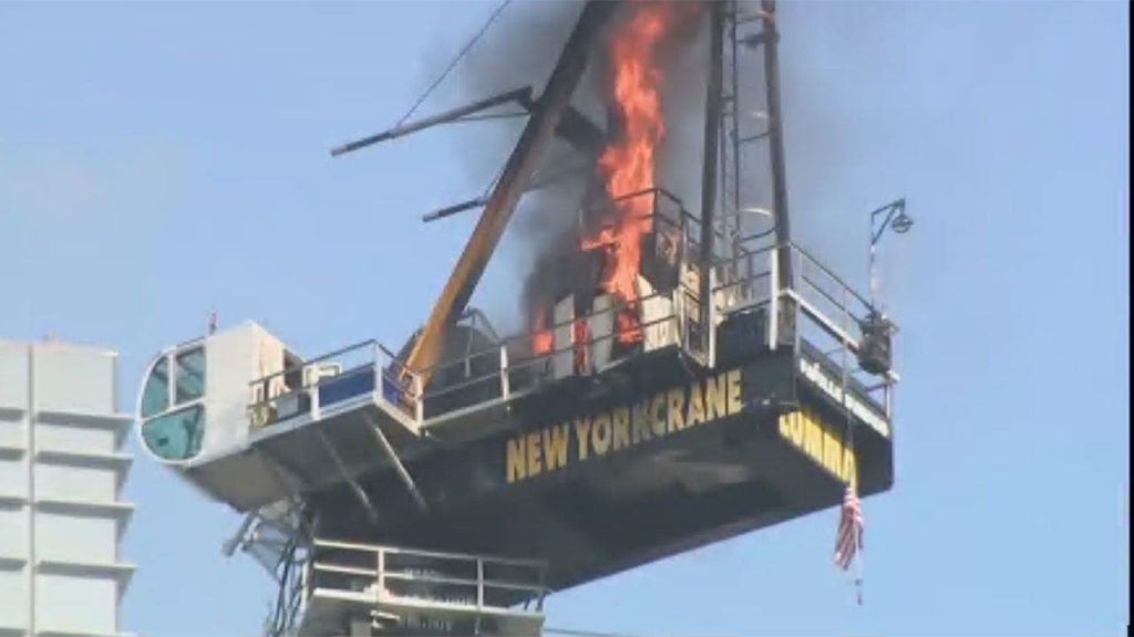The crane could be seen on fire after its arm collapsed in Manhattan.