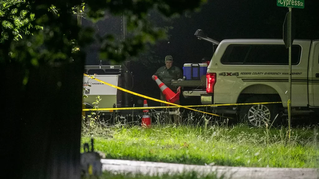 Members of several law enforcement agencies investigate the scene where Brandy McCaslin and her three children were killed after a hostage situation on Thursday, July 20, 2023, in Verdigris, Oklahoma