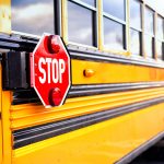 Kentucky School System Shuts Down Following Transportation Fiasco Close up of a yellow school bus with the red STOP sign